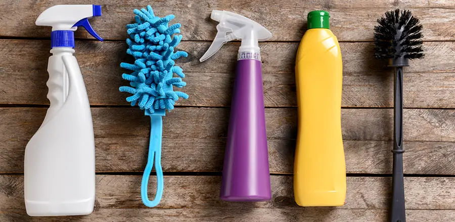 Cleaning supplies on wooden background