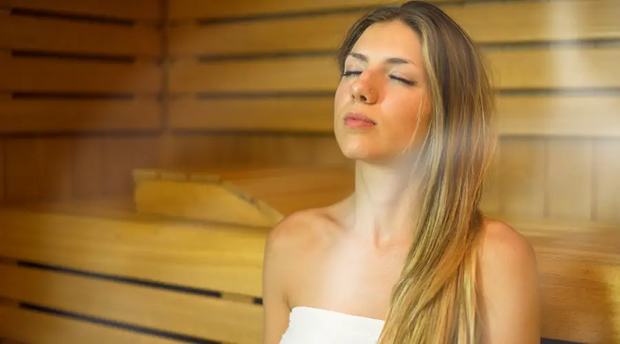 Woman using a sauna with steam in it