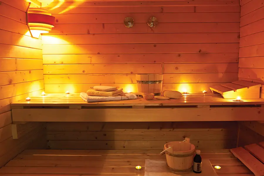 Interior of a Finnish wooden sauna with candles lit