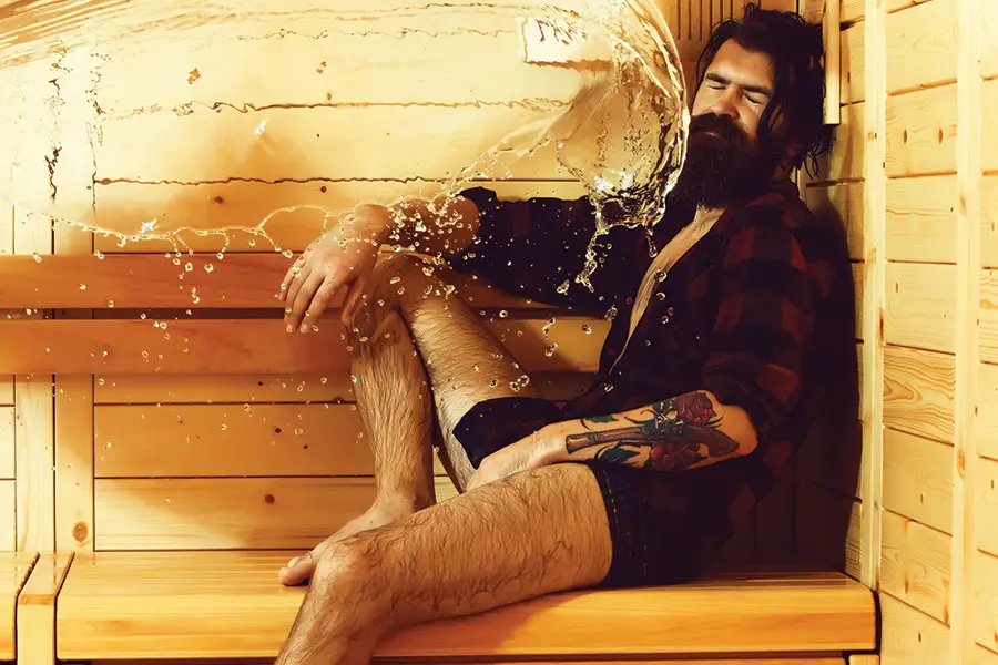 Splash of water on man on wooden background