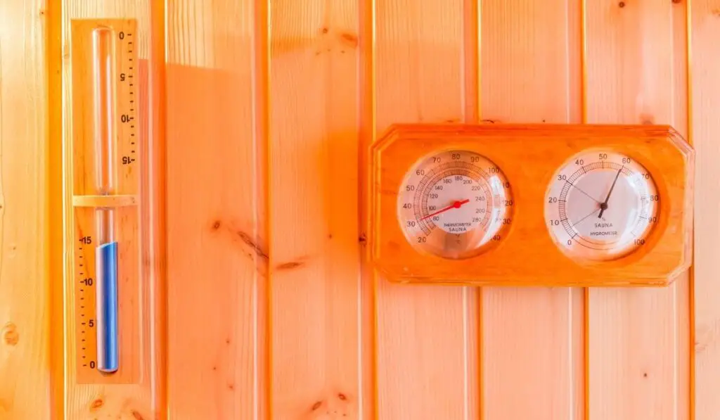 Bath thermometer, hourglass decorated on interior wooden wall 