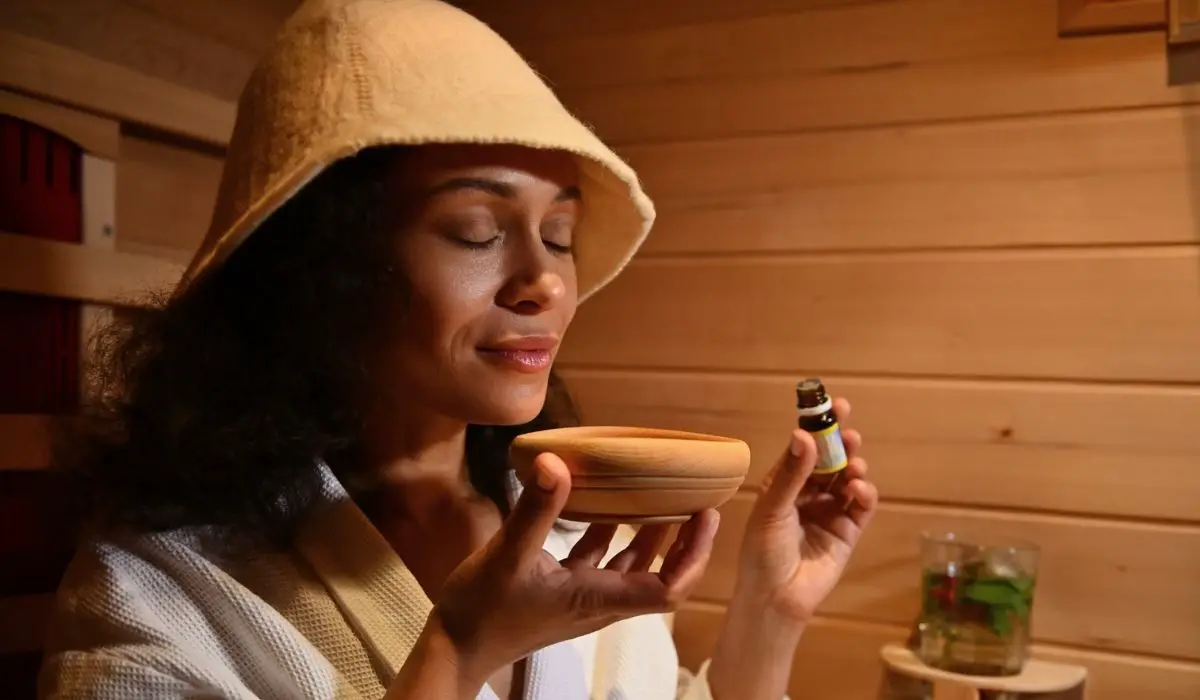 Beautiful serene Hispanic woman enjoys the aroma of essential oil