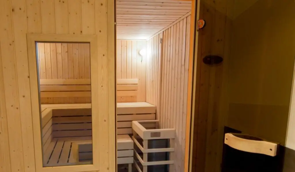 Wooden sauna with glass door