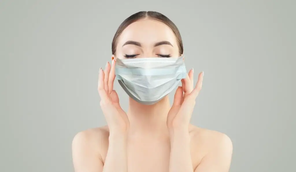 Healthy model woman in protective mask