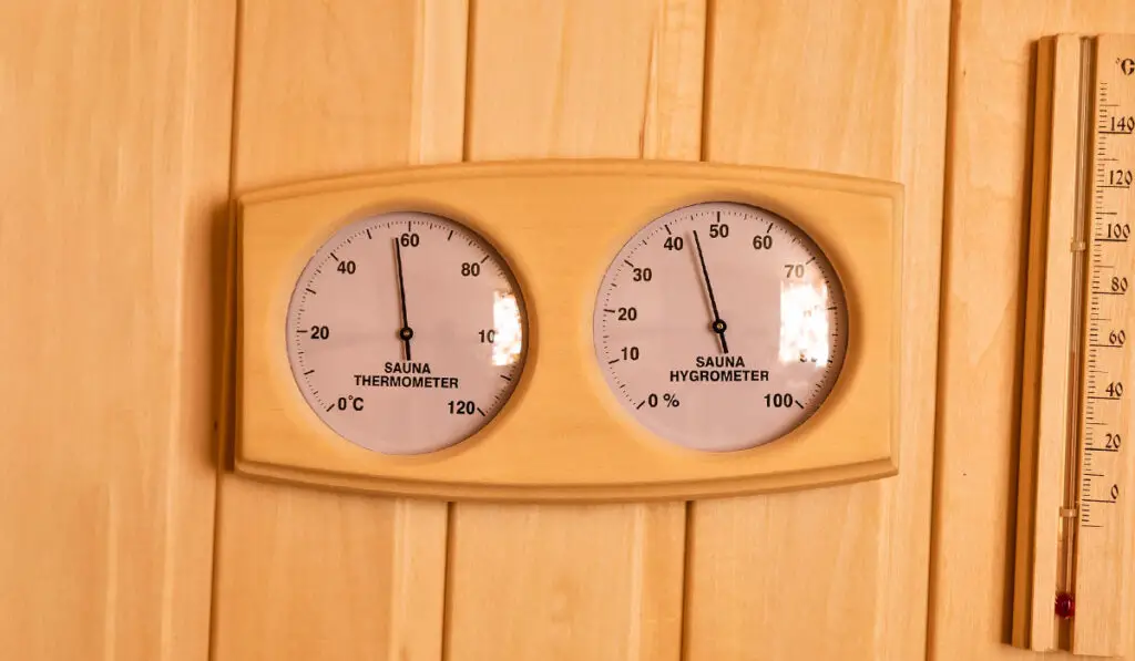 Sauna thermometer and hygrometer on wooden wall