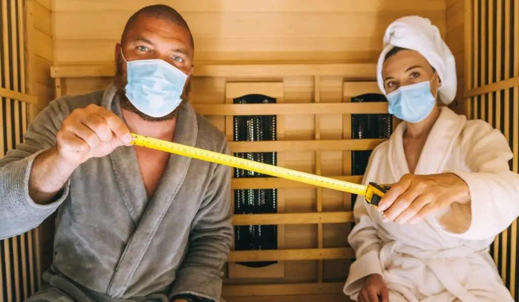 Using medical face masks and measuring social distance in a small infrared sauna