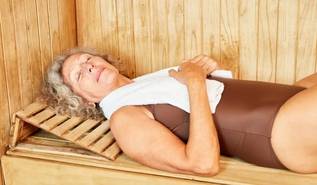 Senior woman is sleeping peacefully in the sauna