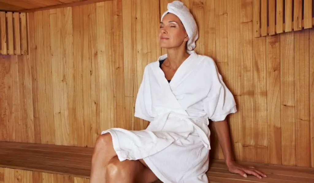 Senior woman sitting in sauna